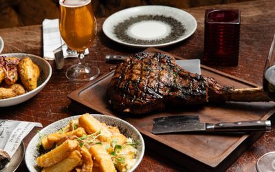 ribeye served on wooden board with potatoes
