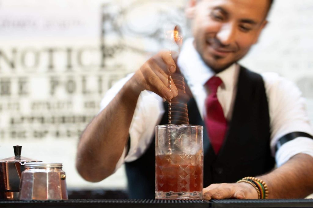Bartender mixing cocktail