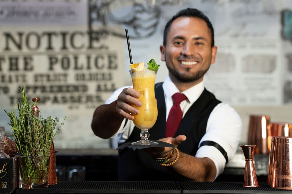 bartender serving lemon vodka cocktail