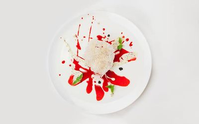 Dessert served on a crisp white plate with vanilla ice cream and a splash of red sauce. The pass has often been in the Michelin guide as an exceptional Sussex Restaurant