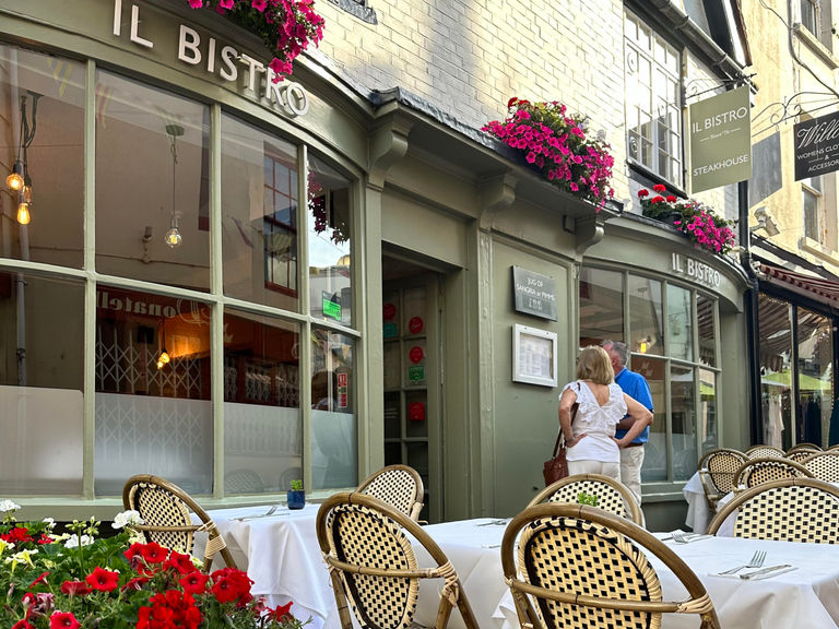 Diners looking into Il Bistro in Brighton's Lanes. Green facade