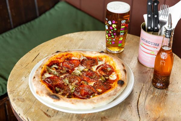 side over head shot of the vegetarian pizza served with pint