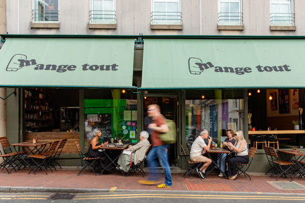 exterior shot of Mange Tout, people sitting outside the venue