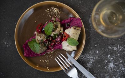 Overhead shot of artichoke dish with knife & fork