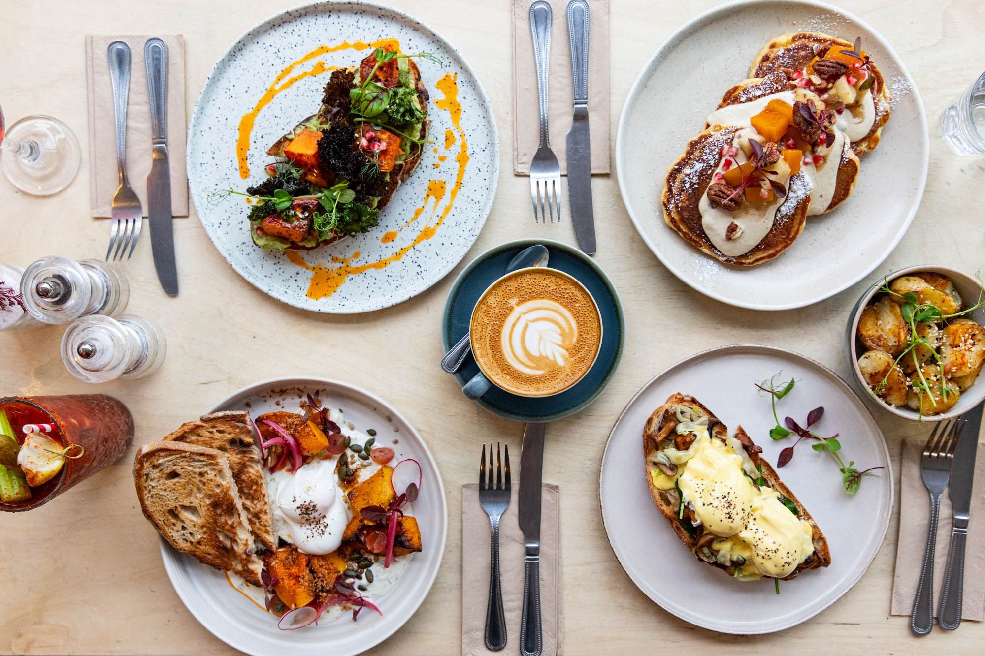 over head shot of the table laid out with brunch dishes including egg on toast, pancakes, potatoes at sides. Starfish and Coffee