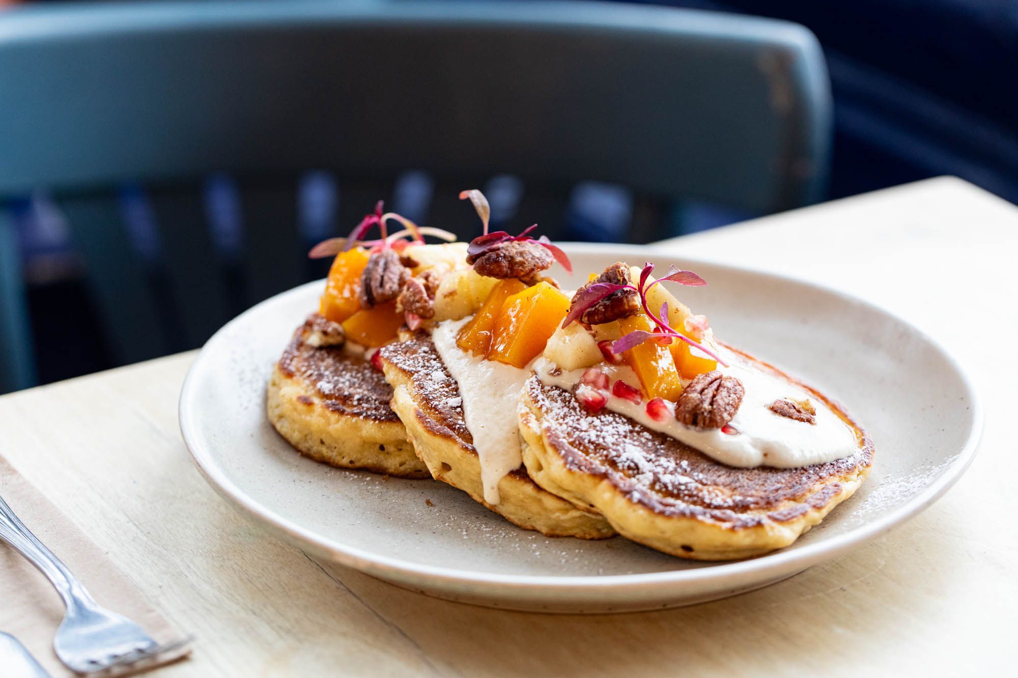 pancakes on the white plate covered with white cream at Starfish and Coffee