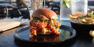 K-Pop burger on the sunny terrace with a carafe of water
