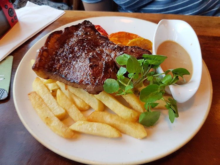 Steak with a blue cheese sauce and chips at The Plough Inn
