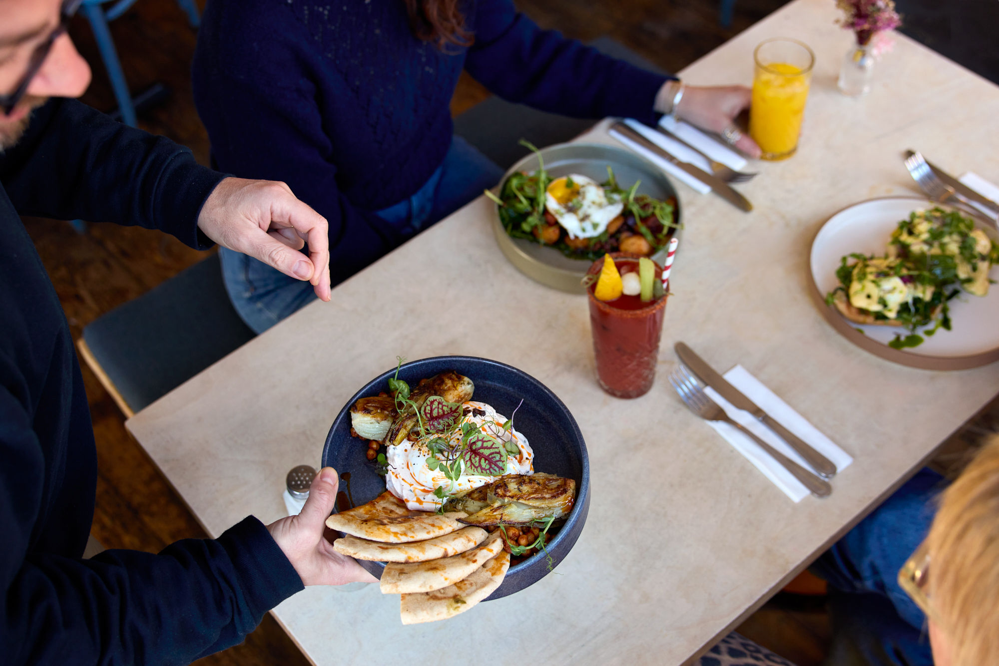 Tony adding another brunch plate to the table