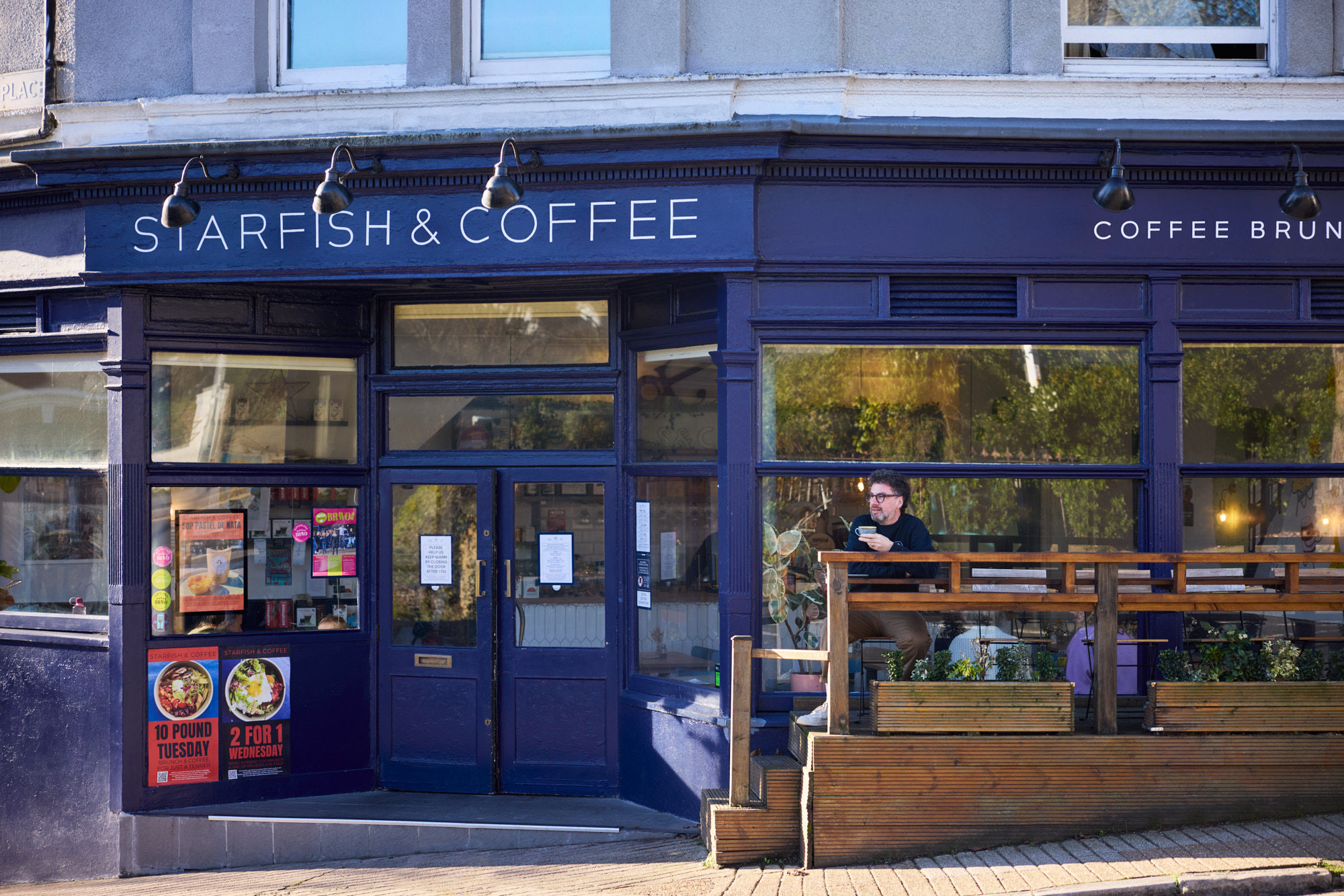 Starfish and Coffee - exterior shot of the venue with Tony sitting and having a coffee in front of it