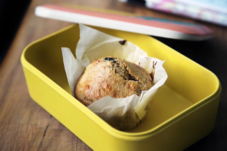 Packed lunches, muffin in a yellow lunch box