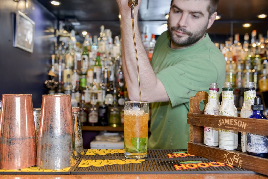 Bar man making cocktails
