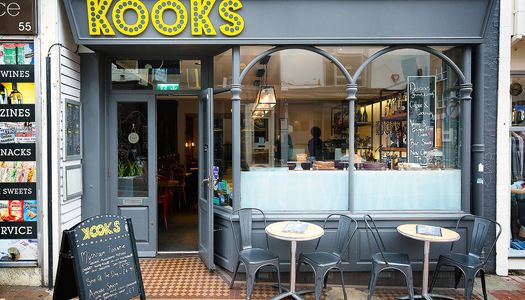 Exterior of Kooks Brighton with outside seating on the street.