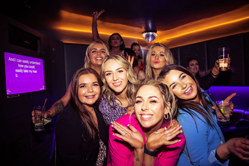 A group of 6 ladies enjoying karaoke at Lucky voice Brighton. A karaoke screen in the background. One of Brighton's favourite karaoke bars. Karaoke Brighton. New Years Eve Brighton