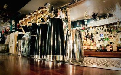 A close photograph of the bar with cocktail mixing glasses