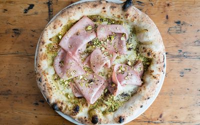 Speciality pizza topped with mortadella ham, fiordilatte, pistaschio and provola. italian restaurant in Brighton