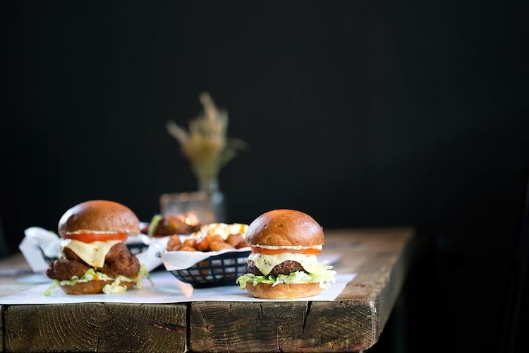 Two chicken burgers side by side. 