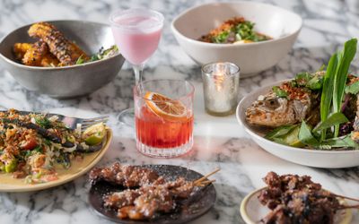 table laid out with different dishes and cocktails