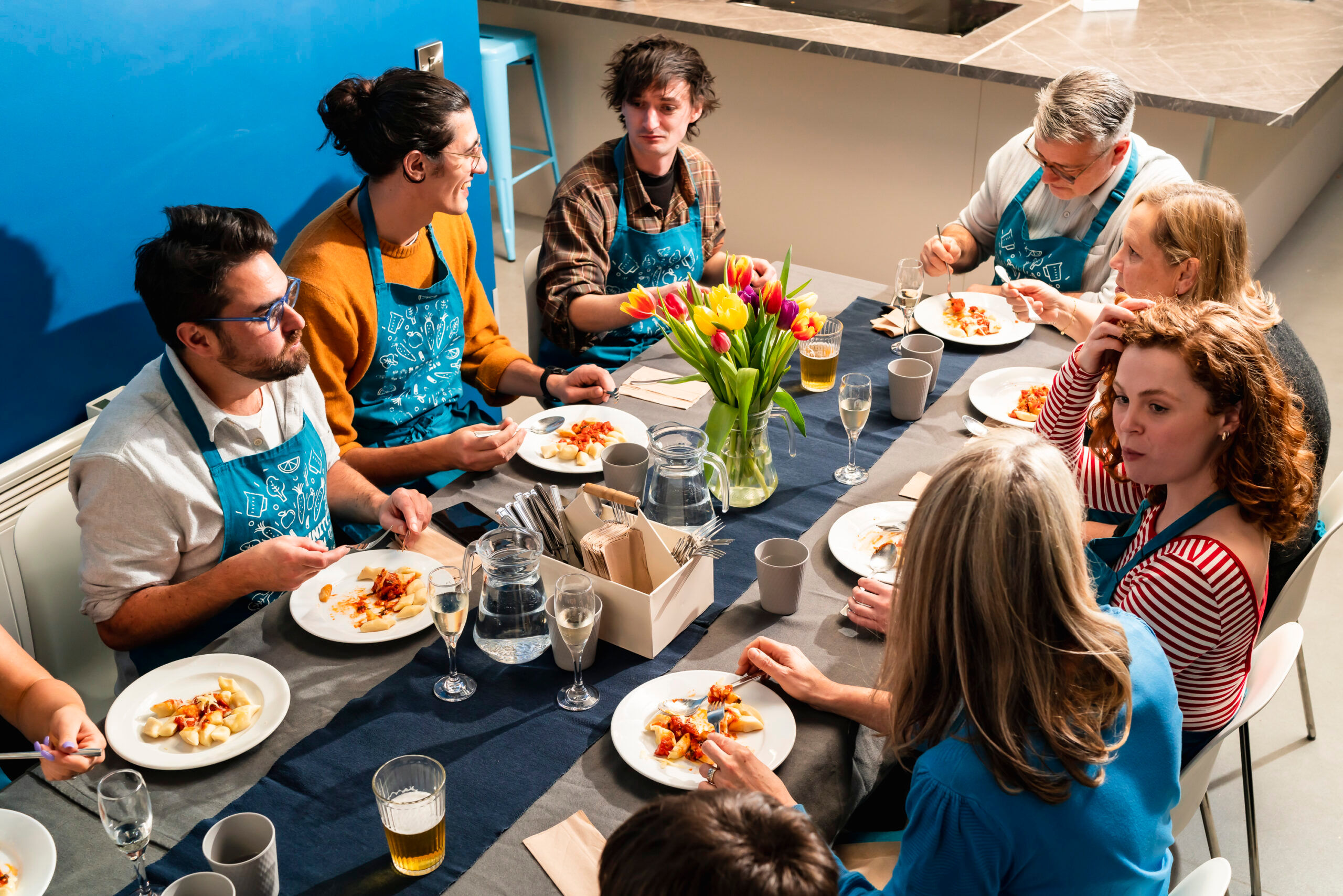 Brighton Community Kitchen - people at the cooking class sitting and eating the dish they prepared