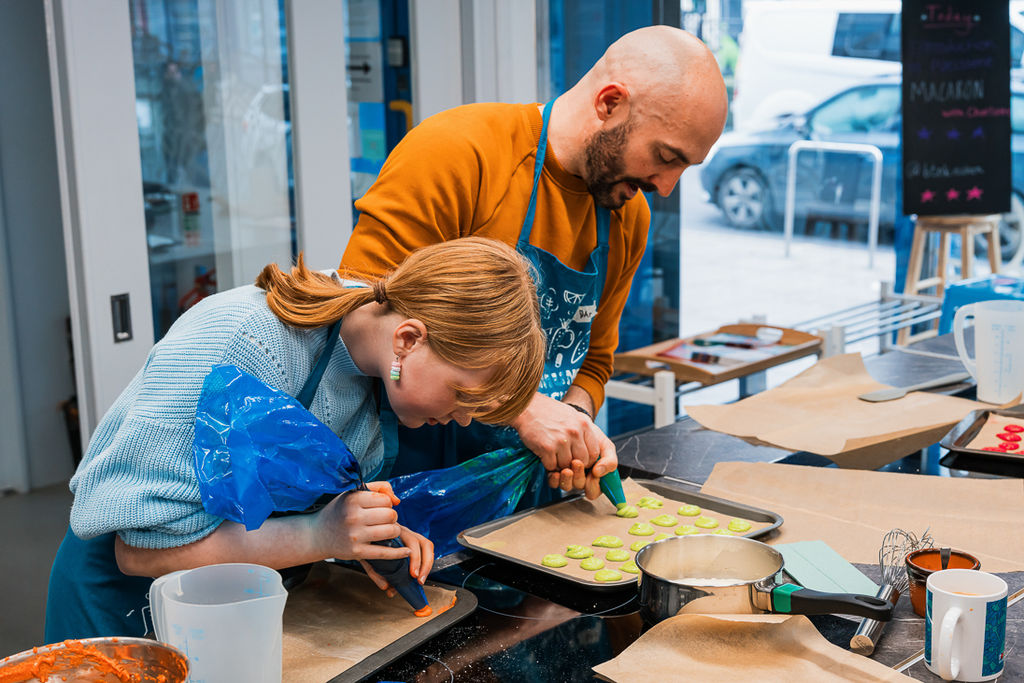 couple preparing the dish at cooking class