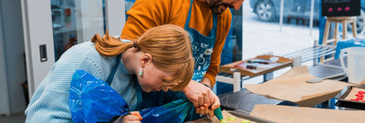 couple preparing the dish at cooking class