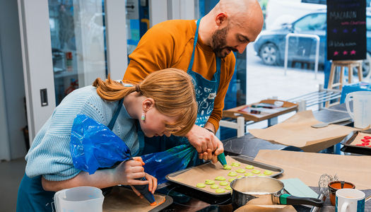 couple preparing the dish at cooking class