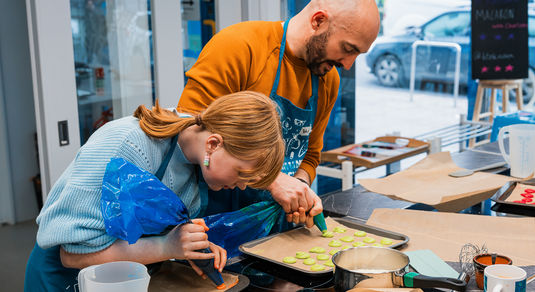 couple preparing the dish at cooking class
