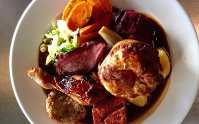Overhead shot of a roast dinner with Yorkshire pudding and gravy