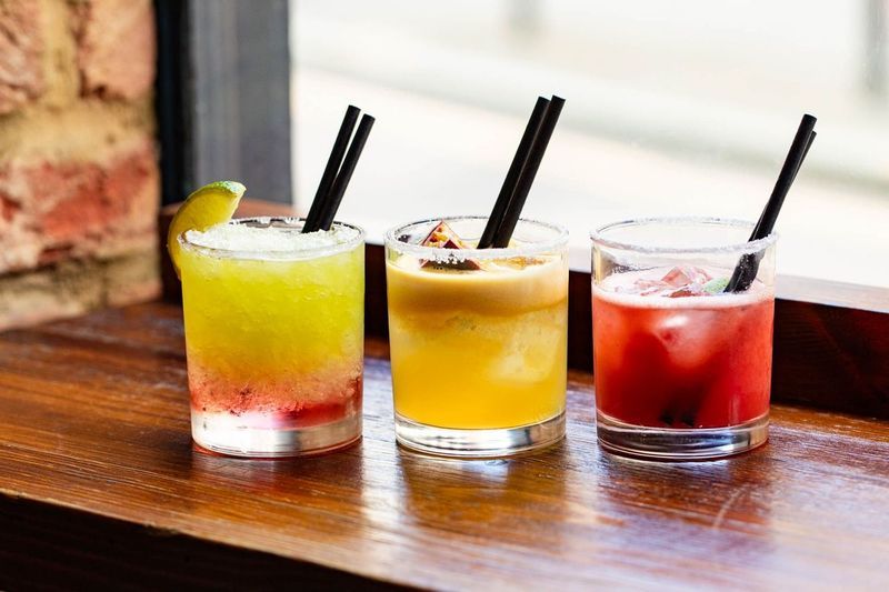 three types of cocktails next to each other on the window table