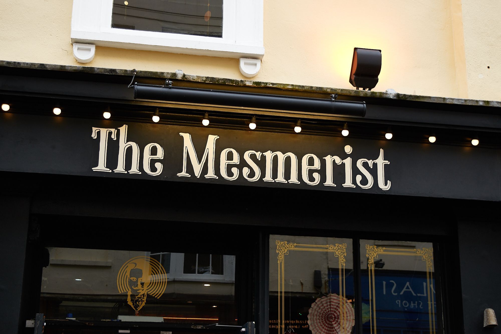 The Mesmerist exterior shot of the venue name written on black wall