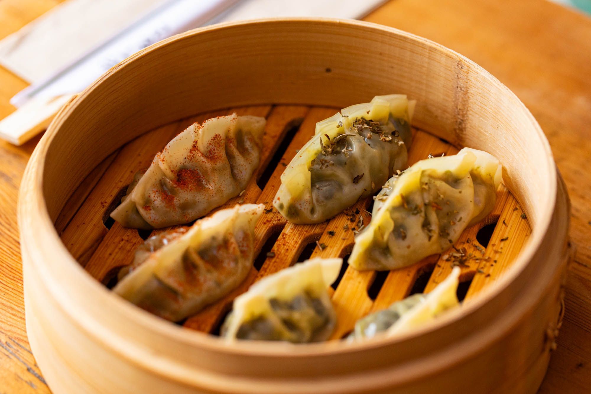 dim sum in the light brown wooden bowl at Gungho Bar