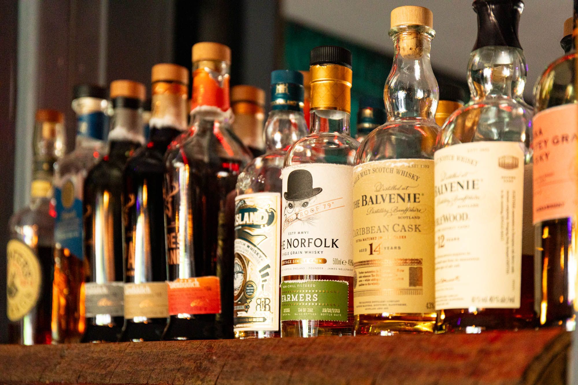 alcoholic drinks on the wooden shelf of Gung Ho bar