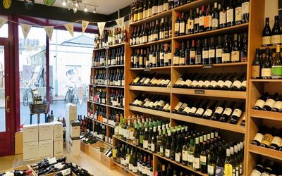 Shelves stacked up inside the shop with bottles of wine. Alcohol Delivery Brighton