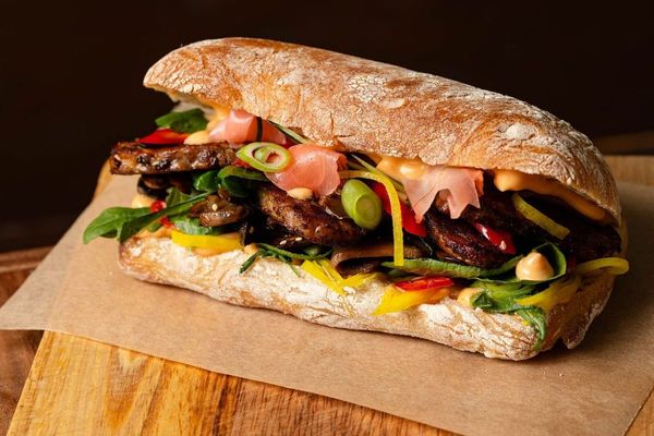 social board sandwich filled with meat and veggies