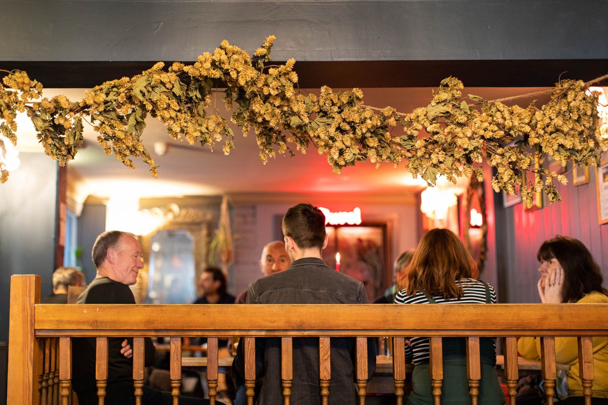 people enjoying their drinks at the pub table