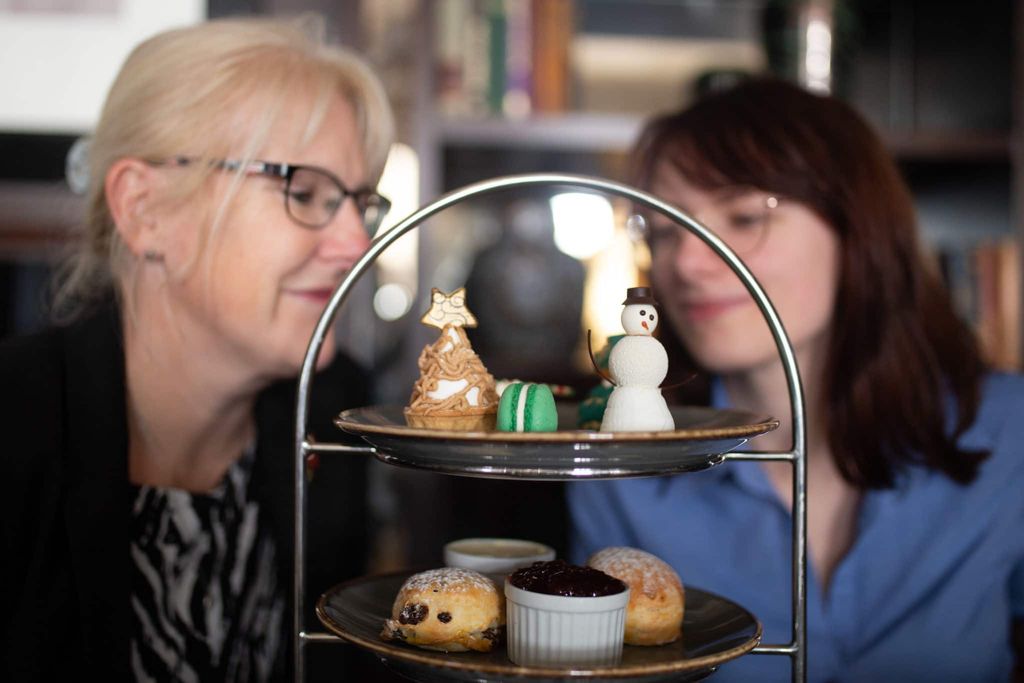 Brighton Christmas picture. Two ladies overlooking the festive afternoon tea in the Metropole hotel. Pictured, snowmen. mince pies and scones with cream.