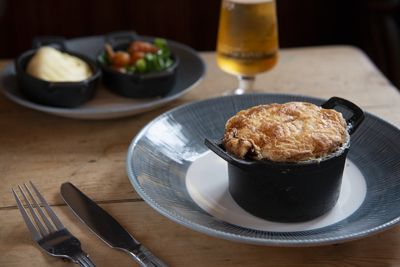 Individual meat free pie with vegetables and a glass of beer