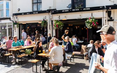 people enjoying sun, food and drinks on The Dorset pubs outdoor seating