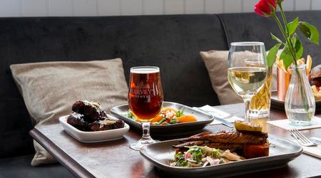 Cushioned indoor seating serving plates of food with a glass of ale