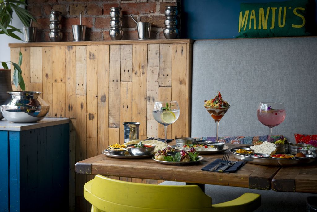 wooden panelling against a green wall. Southern indian dishes and cocktails. 