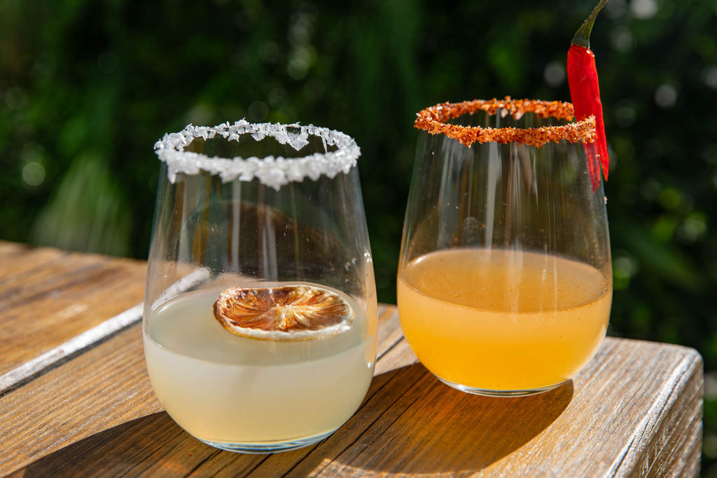 two cocktails served on the table in the garden