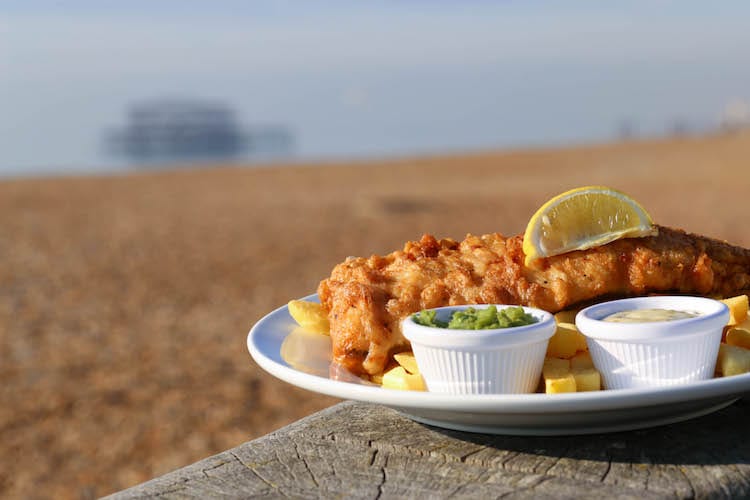 Fish & chips served with a wedge of lemon along with small pots of tartare sauce and mushy peas. Leisurely lunch ideas in Brighton