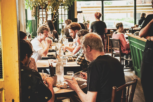 A busy pub with people enjoying their food.
