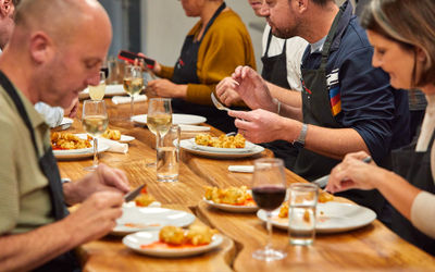 close up shot of the people dining the food they cooked during cooking class