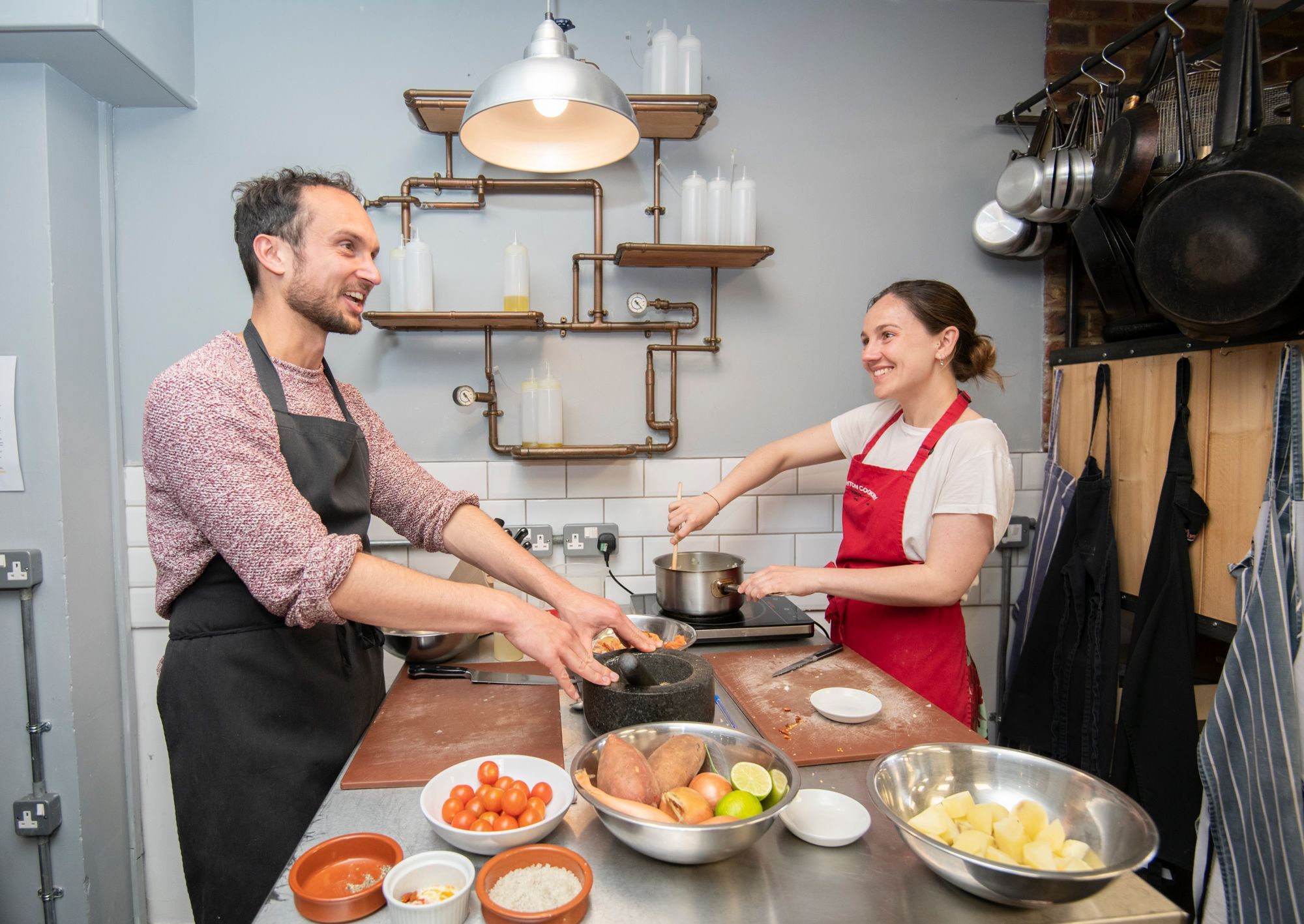 happy cooking couple enjoying their class while smiling and cooking