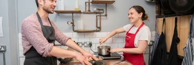 happy cooking couple enjoying their class while smiling and cooking