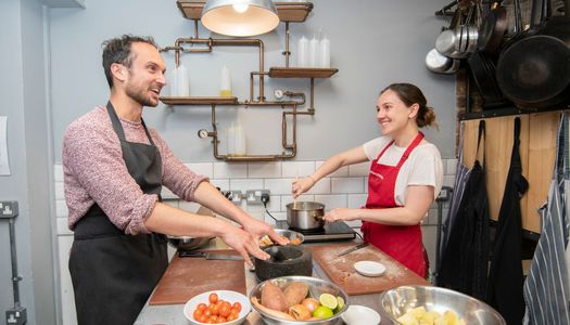 happy cooking couple enjoying their class while smiling and cooking
