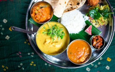 Indian thali platter with a selection curries, rice and chapati.