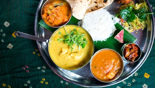 Indian thali platter with a selection curries, rice and chapati.