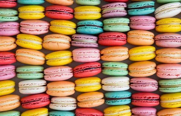 many different coloured macarons next to each other